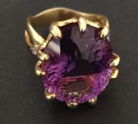 An African silver-gilt amethyst ring, 18x14 mm main stone, with cubic zirconia secondary stones,