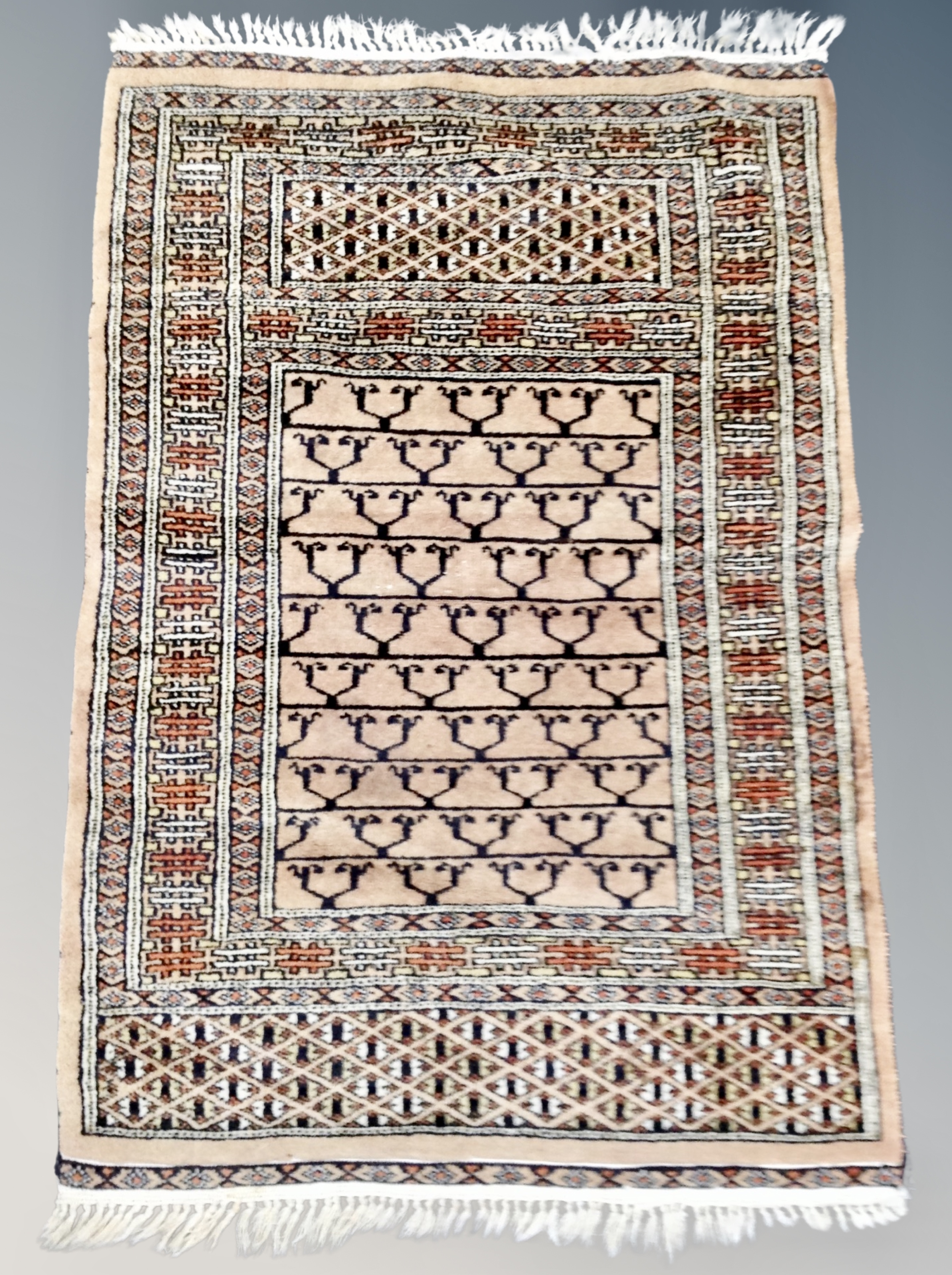 An Iranian prayer rug on coffee ground 92 xm x 61 cm