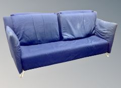 A Scandinavian three seater settee in blue upholstery