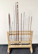 A Guideline fishing rod stand on castors containing four split cane rods