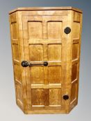 Mouseman : A Robert Thompson English oak hanging corner cabinet,