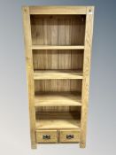 A contemporary solid oak bookcase,