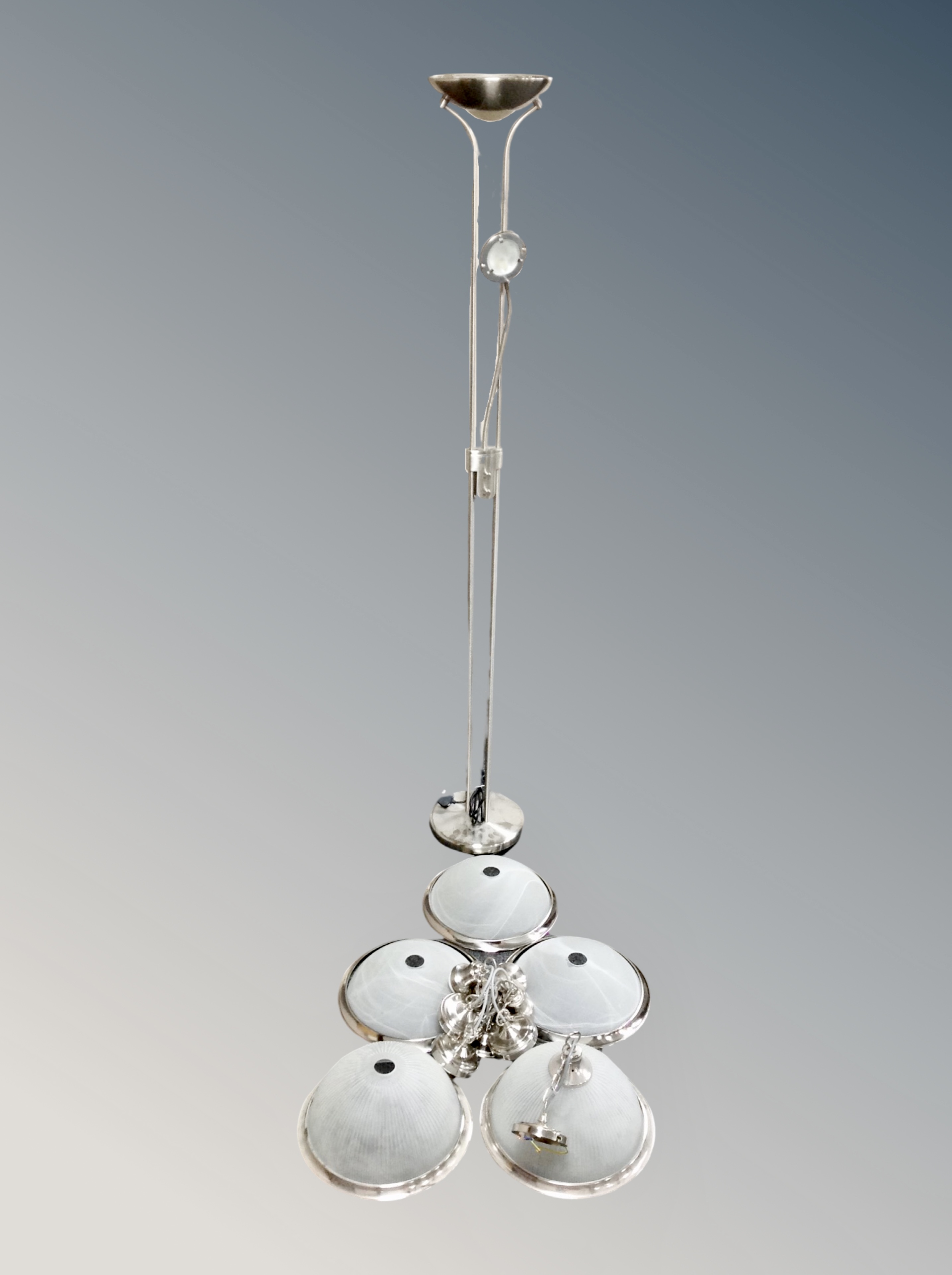 A contemporary uplighter together with six frosted glass pendant light fittings