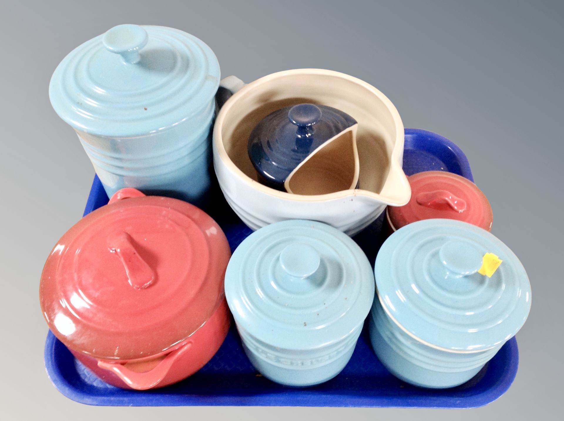 A Le Creuset ceramic casserole dish together with seven various pots
