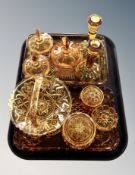 A quantity of amber glass dressing table pieces, basket,