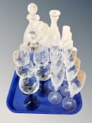 A set of ten frosted glass champagne flutes together with three decanters and five two tone wine