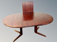A 20th century teak extending dining table with leaf and six chairs