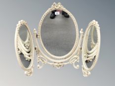 A cream and gilt triple dressing table mirror