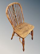 An elm spindle backed chair with crinoline under stretcher together with a two tier occasional