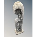 A contemporary abstract garden statue depicting a mother and child,