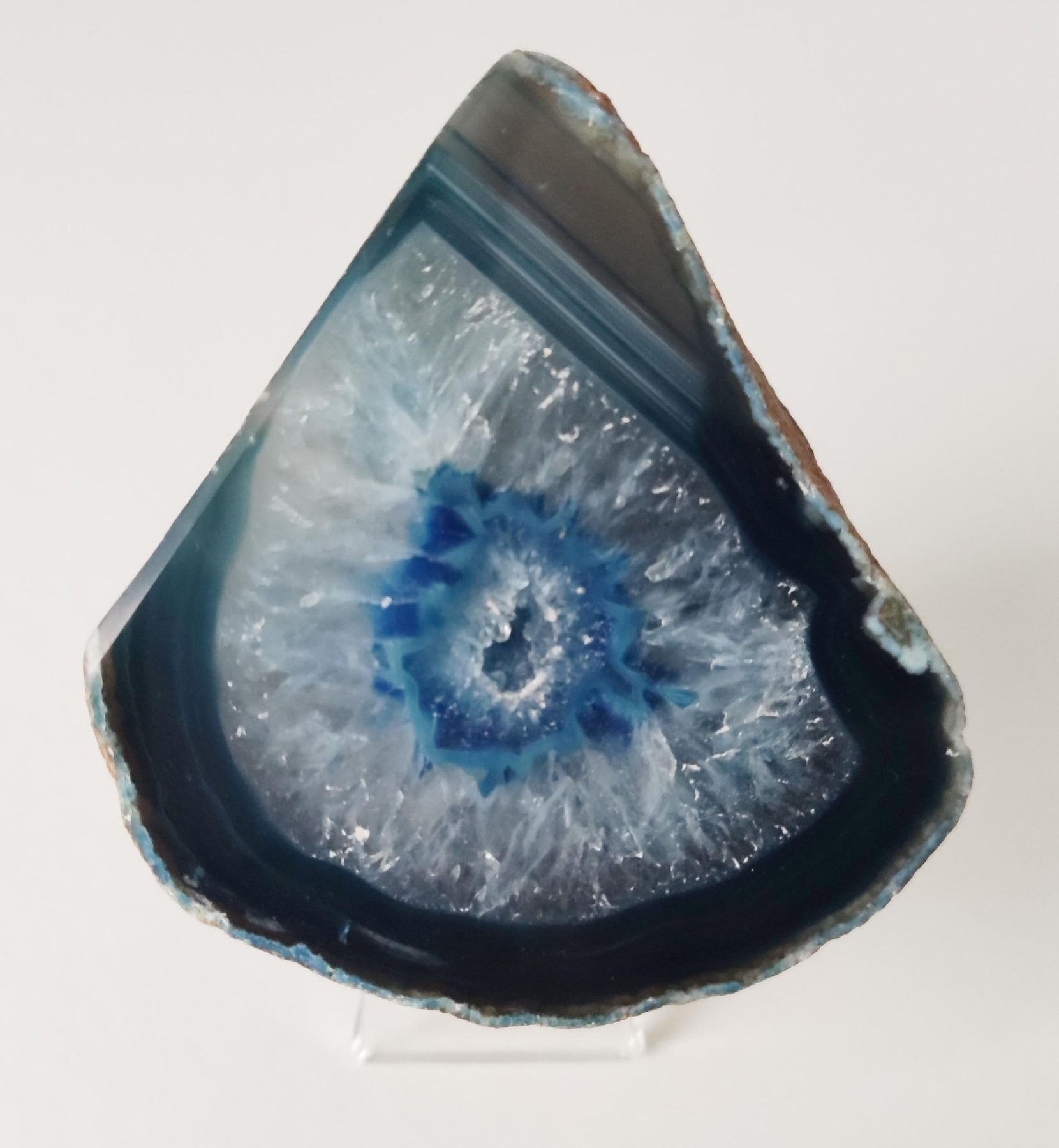 A large blue agate geode crystal slab from Brazil and a purple aura quartz geode from Uruguay.