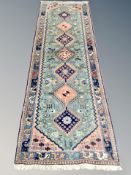 A Caucasian design runner on turquoise ground 251 cm x 80 cm