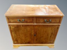 A reproduction yew side cabinet,
