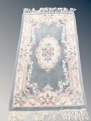 A Chinese fringed rug,