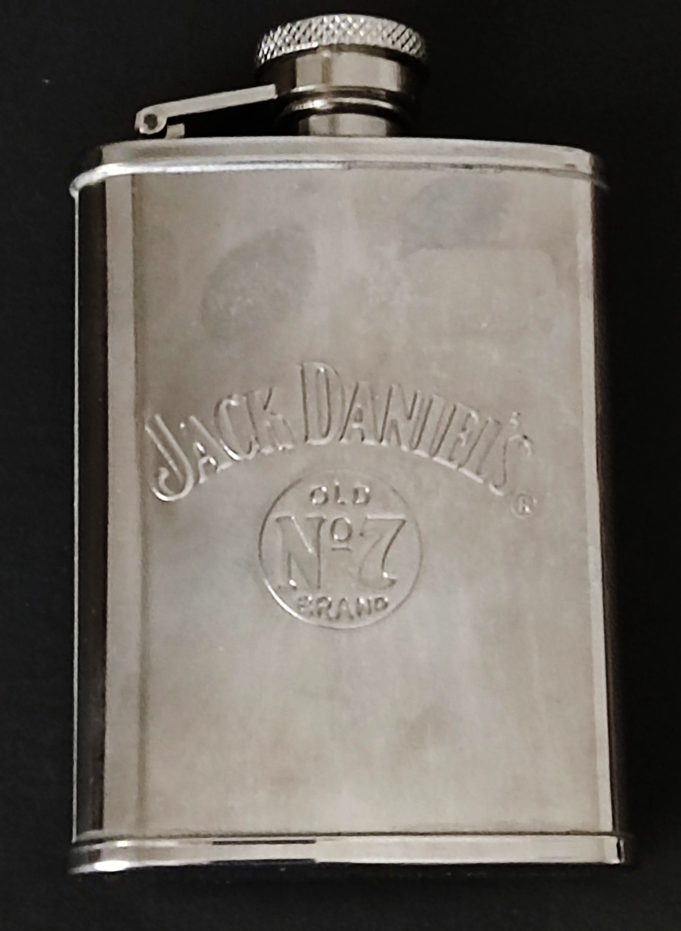 A Jack Daniel's whiskey stainless steel hip flask and a large White Star Line modern Titanic