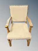 A blond oak armchair in studded fabric