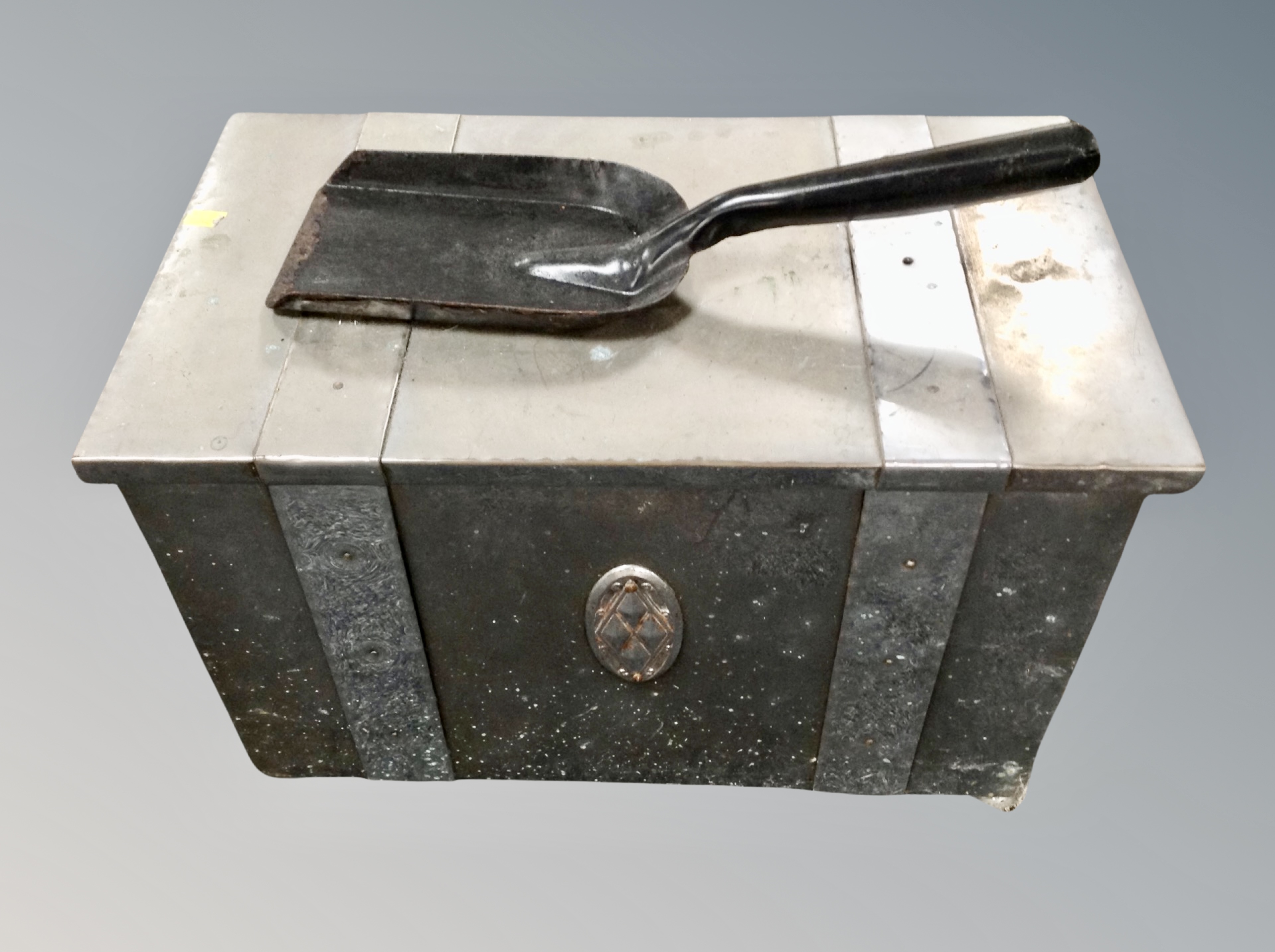 A chrome coal bin with shovel