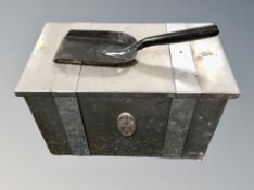 A chrome coal bin with shovel