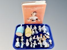 A collection of china half dolls together with a related volume