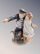 A Lladro group figure of a sailor with child together with two Nao figures and another Spanish