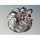 A silver plated four piece tea service on circular tray,