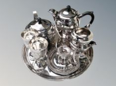 A silver plated four piece tea service on circular tray,