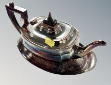 A silver plated teapot on similar stand