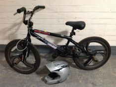 A child's Mongoose BMX bike together with a helmet
