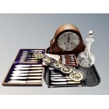 An eight day mantel clock with silvered dial, crystal decanter, horse brasses,