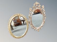 Two contemporary ornate oval mirrors