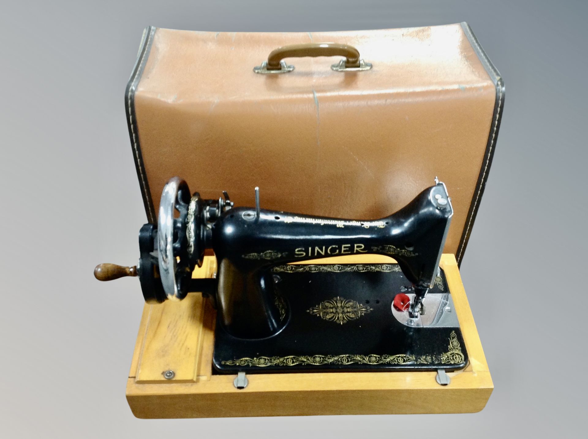 A vintage Singer sewing machine in case