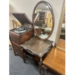 A heavily carved Edwardian shaped occasional table together with a bevelled mahogany mirror