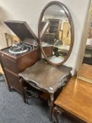 A heavily carved Edwardian shaped occasional table together with a bevelled mahogany mirror