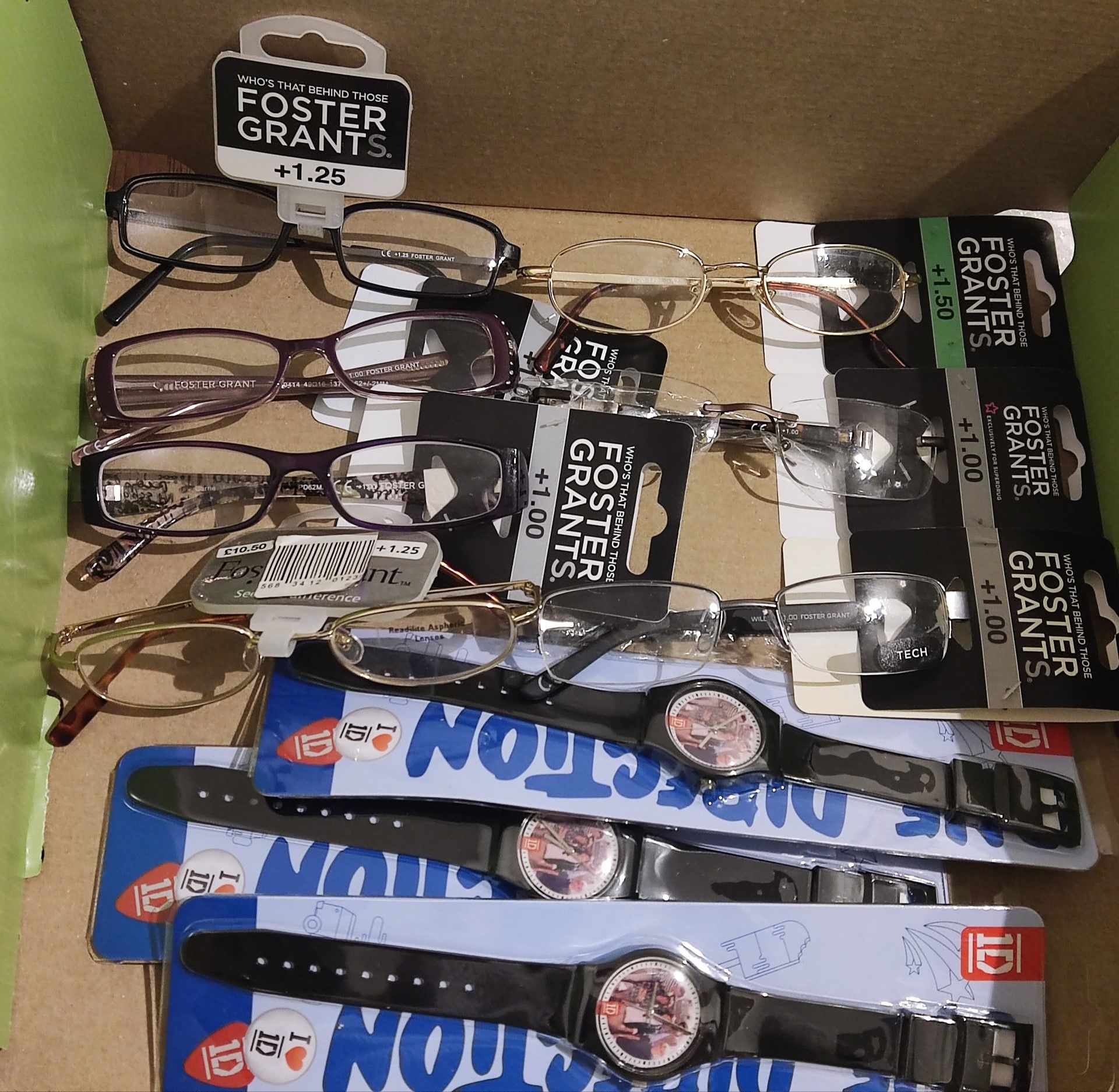 A collection of brand new Foster Grants reading glasses and brand new One Direction watches.