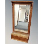 An Edwardian oak framed hall mirror fitted a glove box