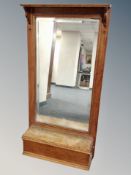 An Edwardian oak framed hall mirror fitted a glove box