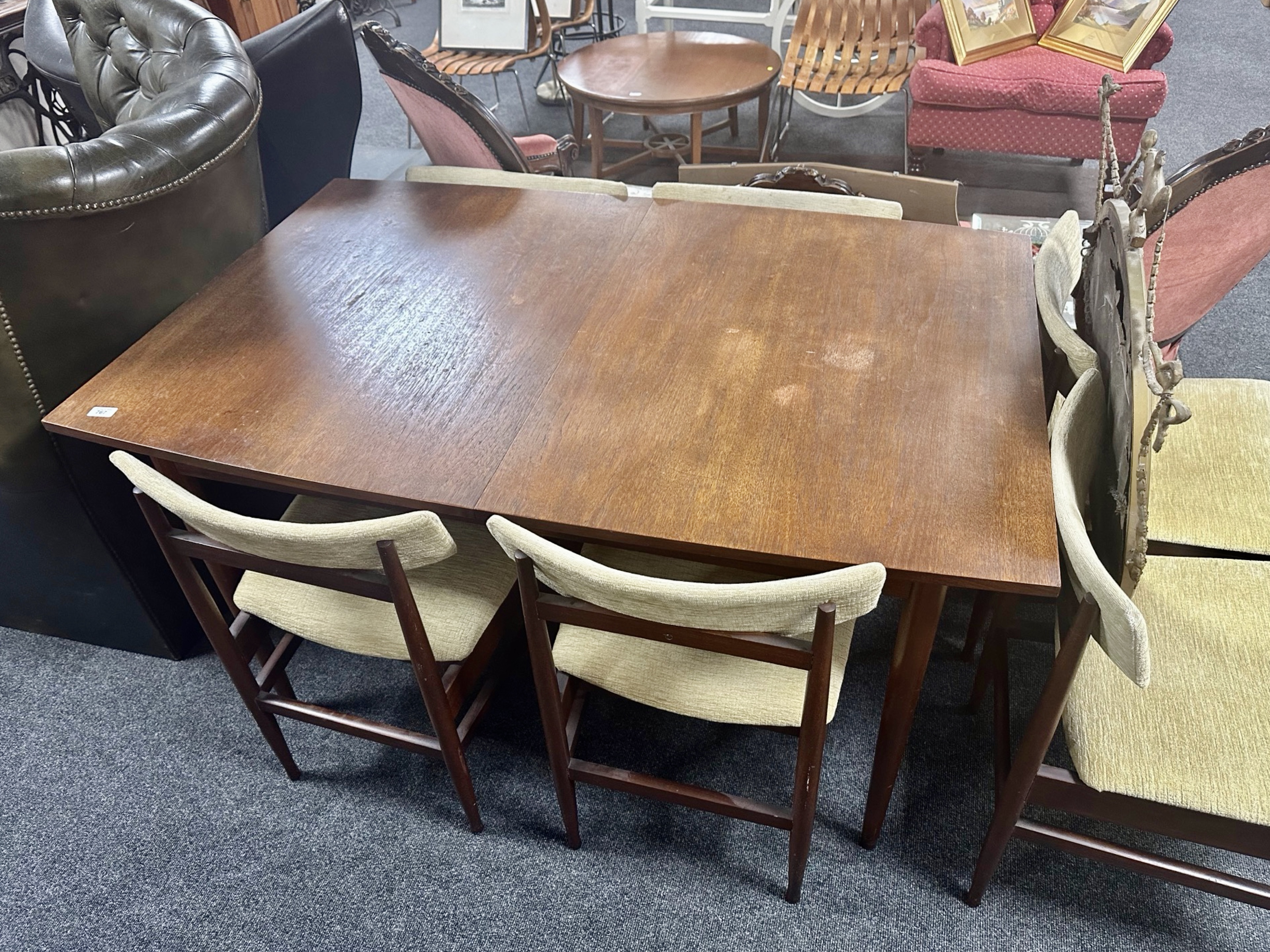 A 20th century teak extending dining table together with six chairs