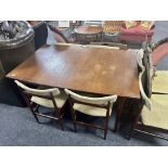 A 20th century teak extending dining table together with six chairs