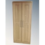 A contemporary double door wardrobe in an oak finish