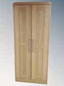 A contemporary double door wardrobe in an oak finish