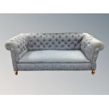 A 19th century drop end Chesterfield settee in blue floral fabric