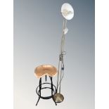 A contemporary tractor style seat bar stool together with a floor standing reading lamp