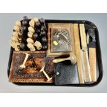 A tray of carved wooden tribal chess pieces, leather wallet,