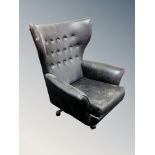 A mid century G-Plan swivel armchair in black buttoned vinyl CONDITION REPORT: