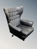 A mid century G-Plan swivel armchair in black buttoned vinyl CONDITION REPORT: