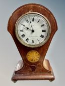 A late Victorian inlaid mahogany balloon mantel clock on brass ball feet CONDITION