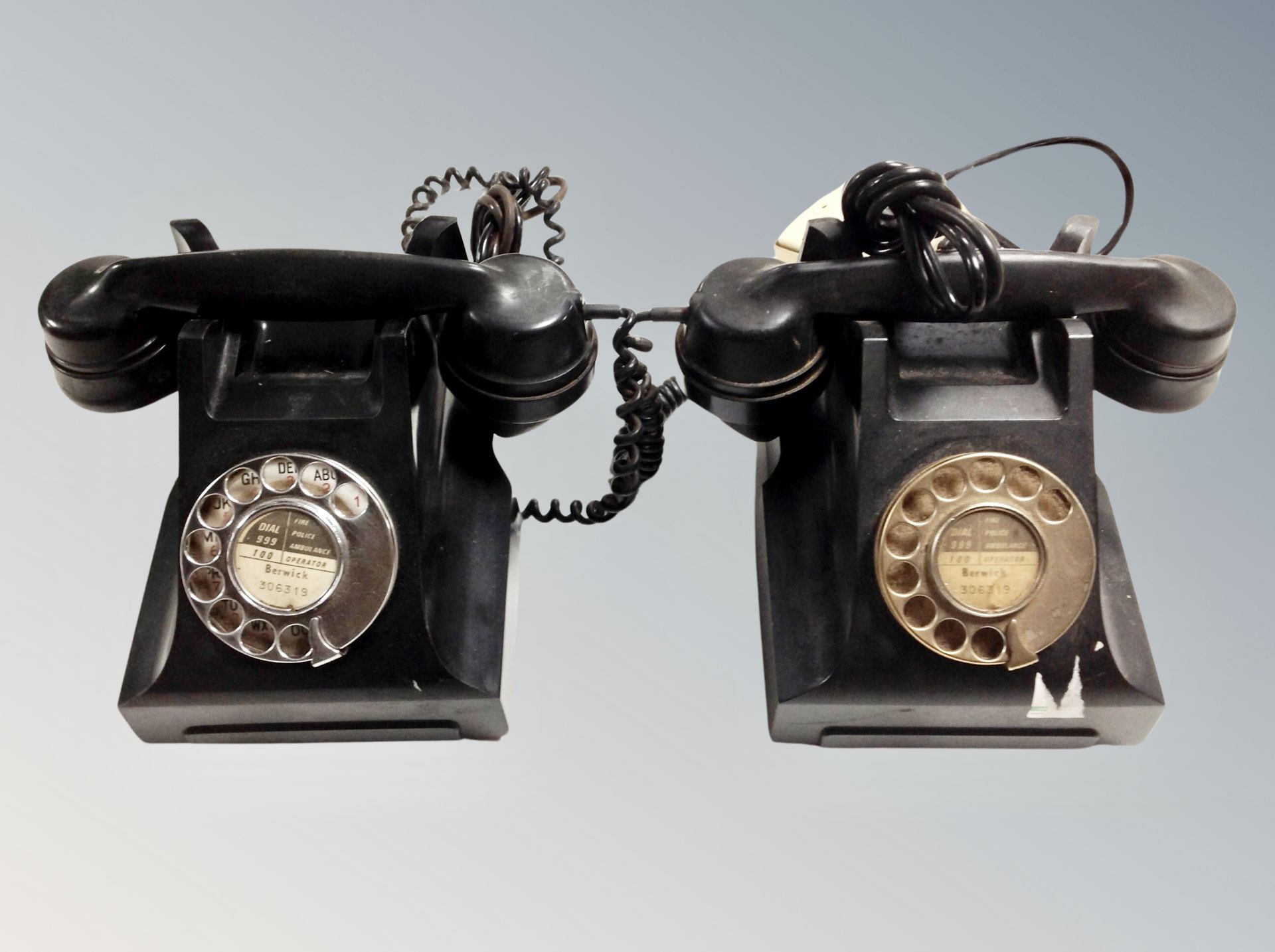 Two vintage black Bakelite rotary telephones
