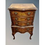 A Regency style walnut serpentine fronted four drawer chest, height 79 cm, width 46 cm, depth 34 cm.