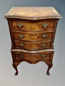 A Regency style walnut serpentine fronted four drawer chest, height 79 cm, width 46 cm, depth 34 cm.