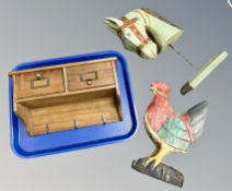 A wooden two drawer rack together with wooden cockerel and horse head figure